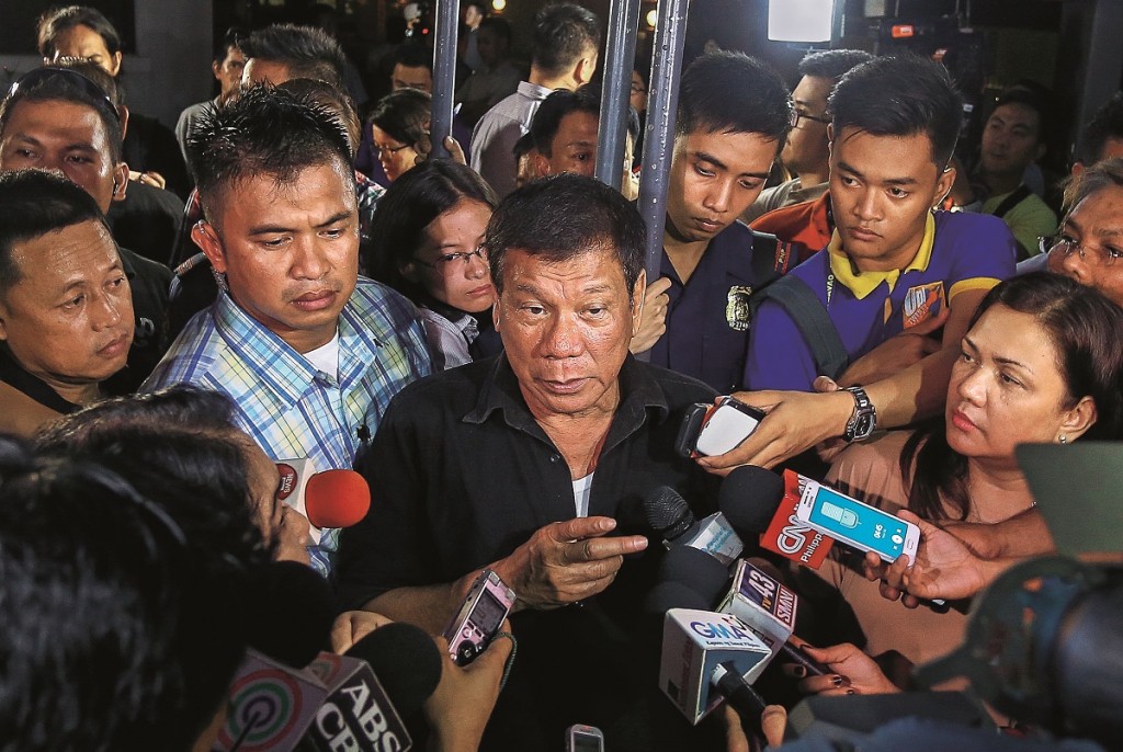 Philippines' president-elect Rodrigo Duterte (C) speaks to journalists in Davao City on June 2, 2016. Rodrigo Duterte warned journalists on June 2, 2016 he would be unable to guarantee their safety, brushing off criticism over his previous comments that murdered corrupt reporters deserved their fate. / AFP / MANMAN DEJETO (Photo credit should read MANMAN DEJETO/AFP/Getty Images)