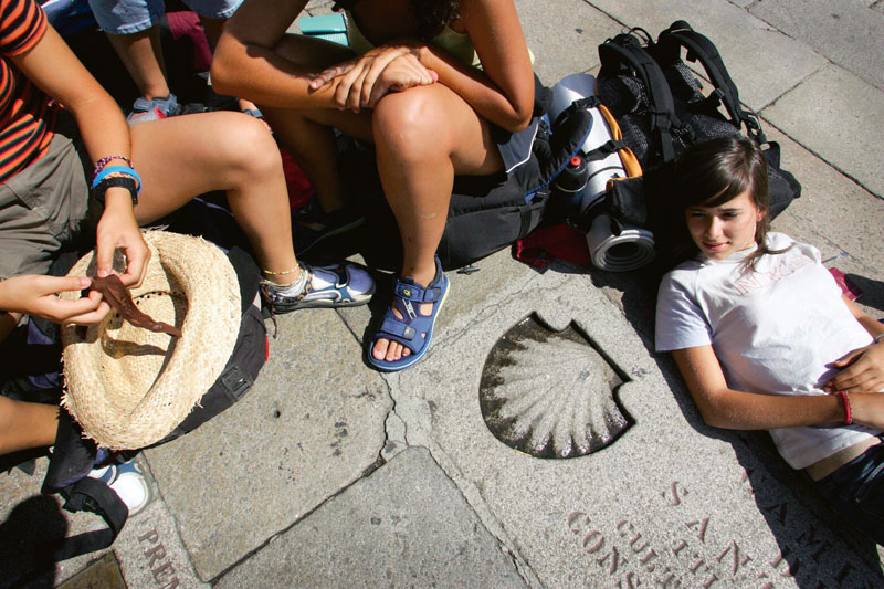 Santiago de Compostela, SPAIN: Pilgrims rest in Obradoiro Square, by the entrance to the mediaeval cathedral of Santiago de Compostela, 21 July 2006. The Portico as well as other parts of the cathedral will undergo extensive restoration over the next 6 years to maintain one of Western Europe's most beautiful mediaeval artefacts. AFP PHOTO/ Miguel RIOPA (Photo credit should read MIGUEL RIOPA/AFP/Getty Images)