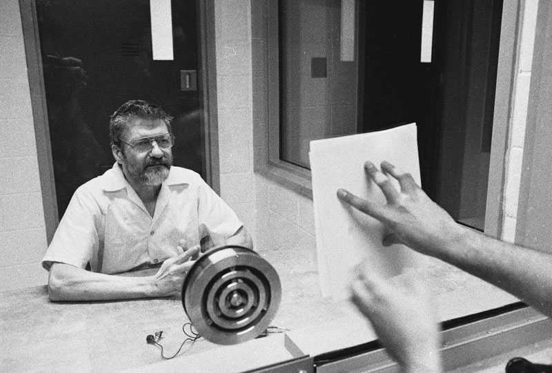 **EXCLUSIVE** American domestic terrorist, luddite, and mathematics teacher Ted Kaczynski looks at a document pressed to the dividing glass by an interviewer during an interview in a visiting room at the Federal ADX Supermax prison in Florence, Colorado, August 30, 1999. (Photo by Stephen J. Dubner/Getty Images)