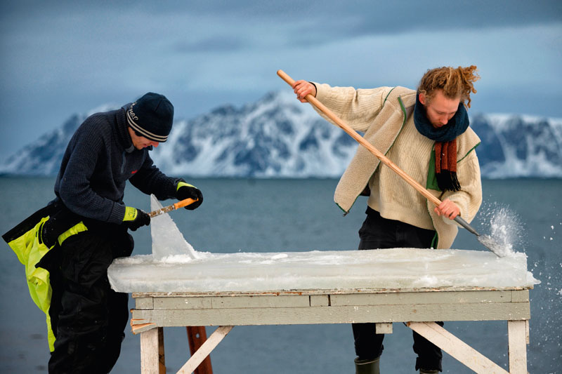 Project leader Inge Tamburaci Wegge, 32, (L) and Swedish surfer Pontus Hallin shape a board out of ice on the Delp surfing sport, near Straumnes, in the Lofoten Islands, over the Arctic Circle on February 17, 2019. - Images can be found on www.afpforum.com with the slug : Surfing-Lofoten-Ice board-Photo essay (Photo by Olivier MORIN / AFP) (Photo credit should read OLIVIER MORIN/AFP/Getty Images)